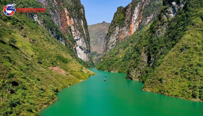 Exploring the mountainside trail on a motorbike, which runs parallel to the river below, offers a charming water landscape