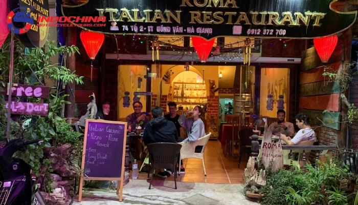 Night view of Roma Italian Restaurant with outdoor seating