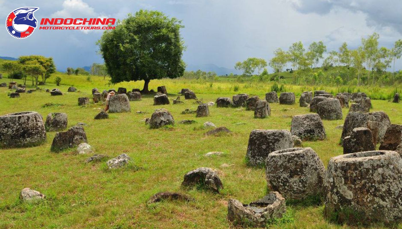 The iconic stone jars in Laos off-road motorbike tours in the background