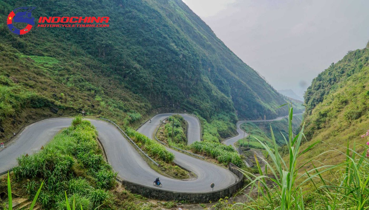 A view of the steep and twisting Tham Ma Slope with a motorbike ascending