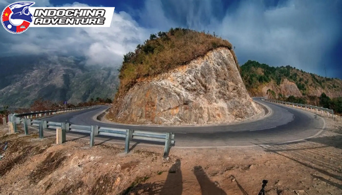 The winding road through towering cliffs beckons an adventurous motorbike journey across Vietnam's legendary mountain passes.