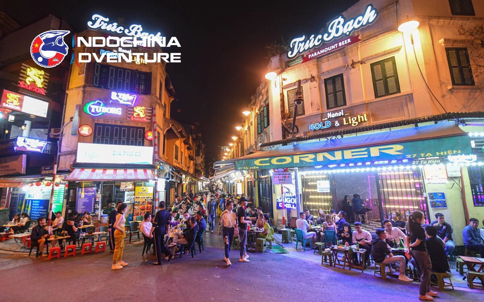 Crowds enjoying beer and street food on lively Ta Hien Street at nigh