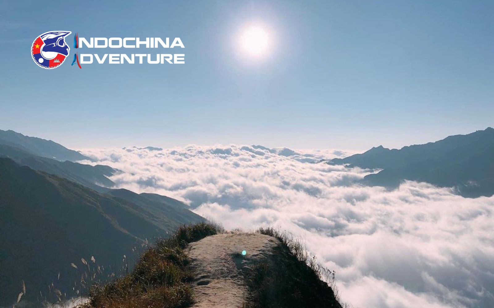 Ride along Ta Xua ridge as clouds drift below and peaks rise around you