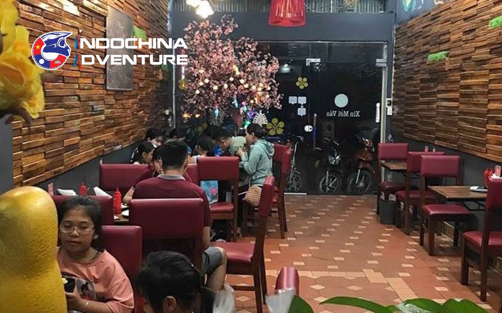 Group of travelers enjoying barbecue and pizza at A Dong restaurant