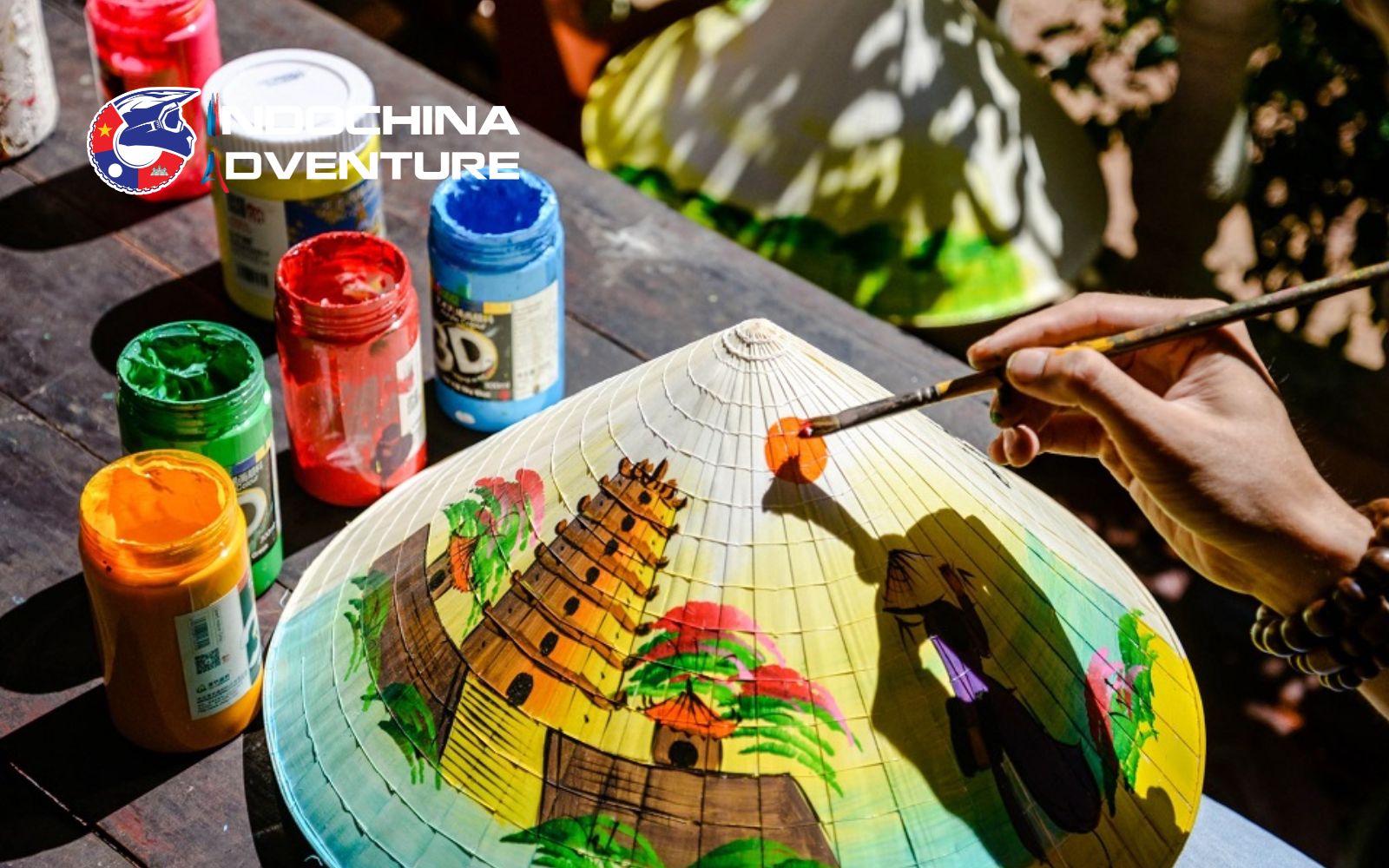 Hands-on cultural craft making perfect for rainy-day activities Visitor crafting a traditional paper flower in a workshop in Hue monsoon months