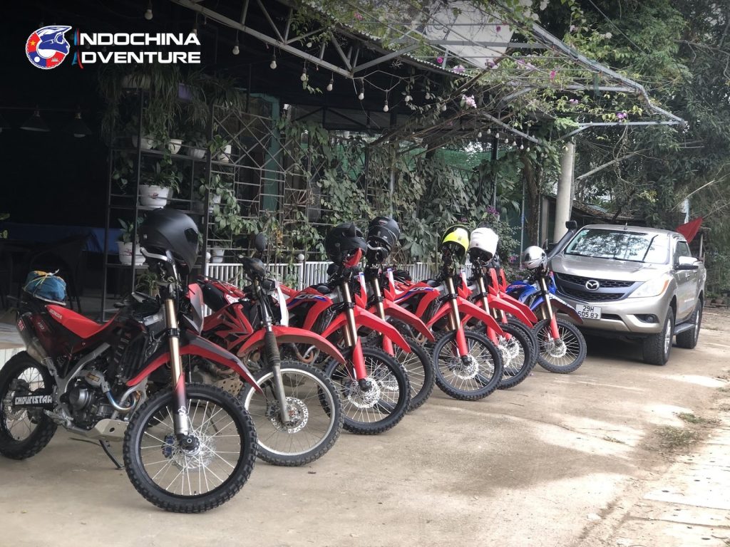 Riders checking helmets, boots and protective gear before an adventure motorbike tour in Vietnam