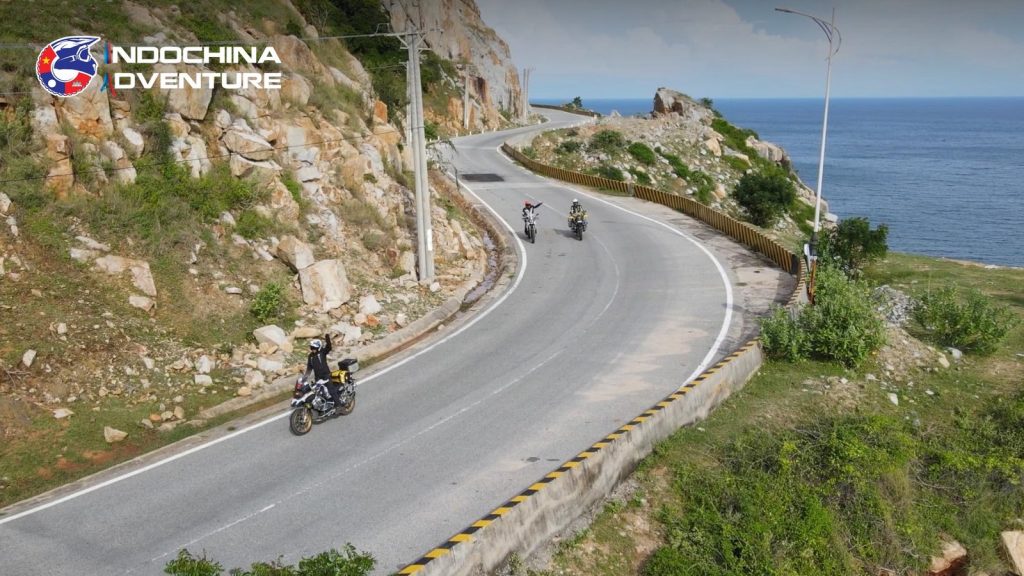 Rider on a bigbike adventure motorcycle on a coastal mountain pass in Vietnam