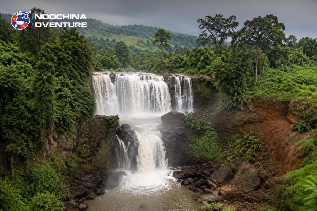 Two tier waterfall surrounded by forest in the Mondulkiri highlands on a Cambodia motorbike tour