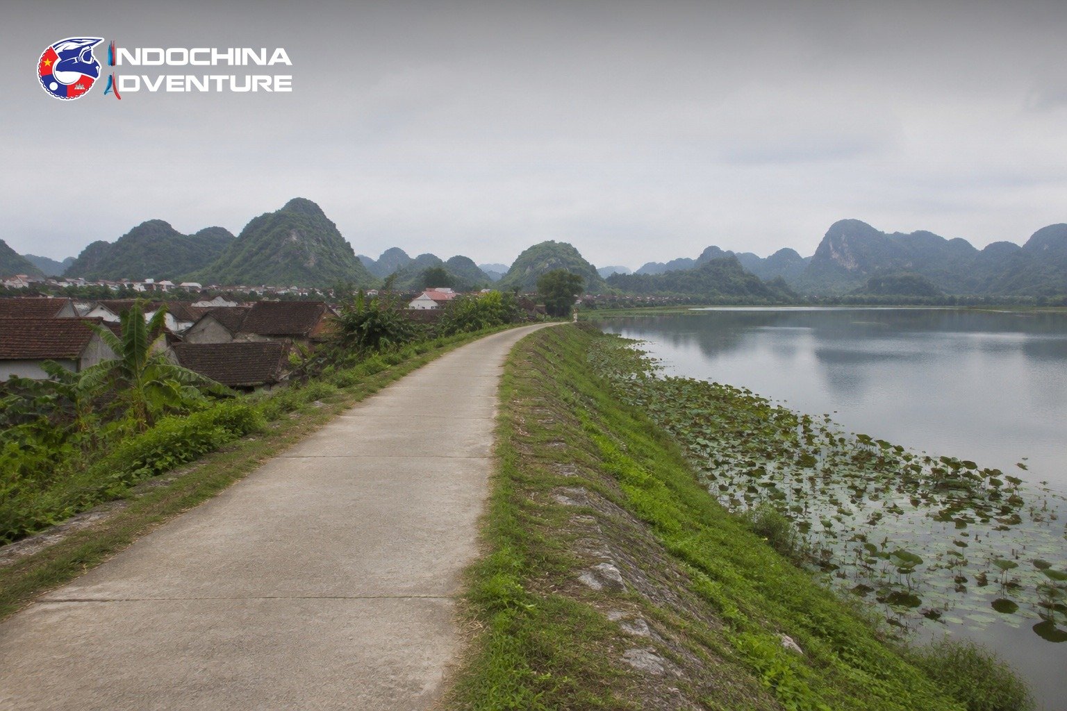 Quiet dyke road through a village on a hidden route near Kenh Ga in Ninh Binh