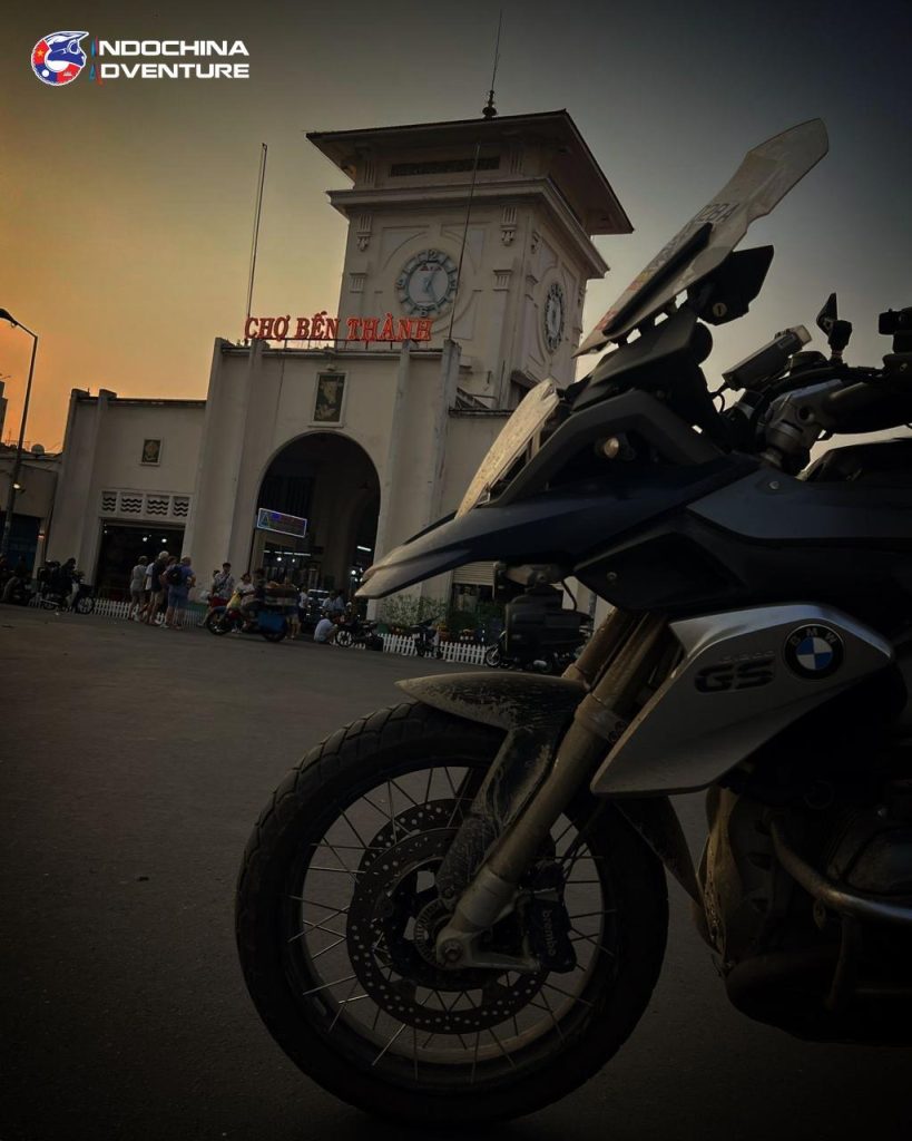 Loaded adventure motorbike outside Ben Thanh Market in Ho Chi Minh City before a Vietnam Laos cross border tour